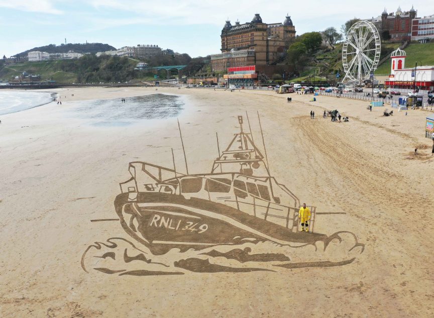 Making waves – sand drawing for the RNLI’s MayDay Mile